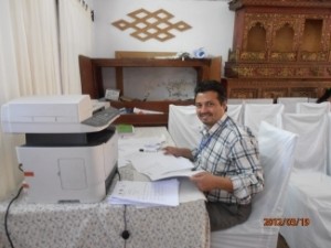 Kumar Regmi sorts through attendance sheets during the training