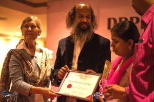 Ms. Shujasri K. of Deque Systems Accepts Award